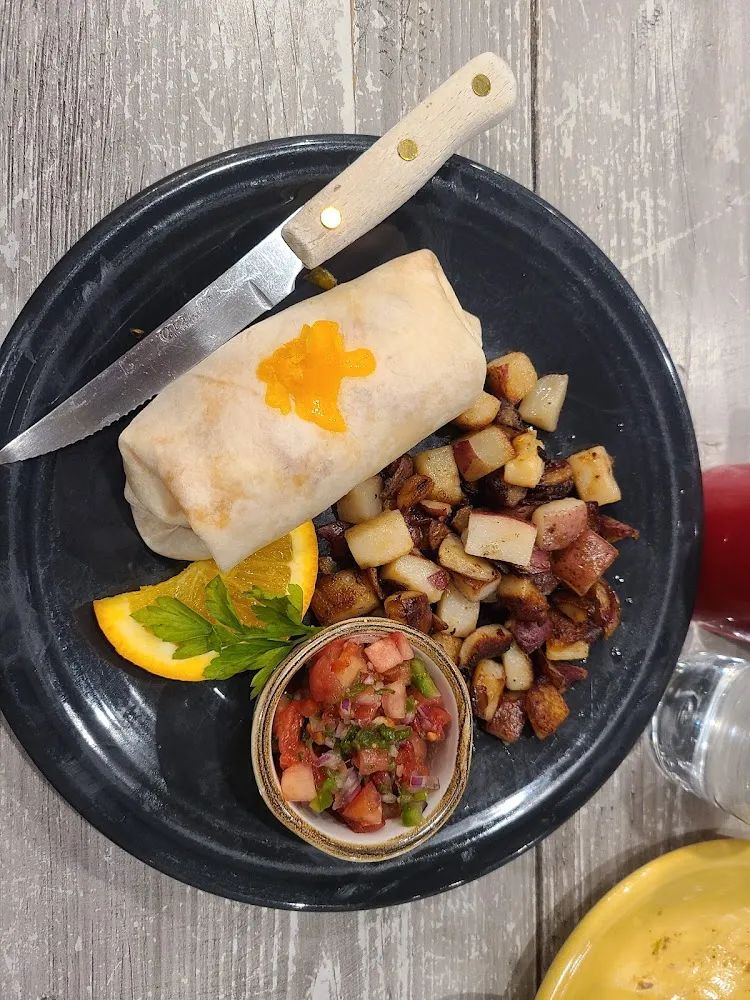 Scrambled Eggs & Cheese Wrapped in a Tortilla Shell Served with Fruit or Potatoes